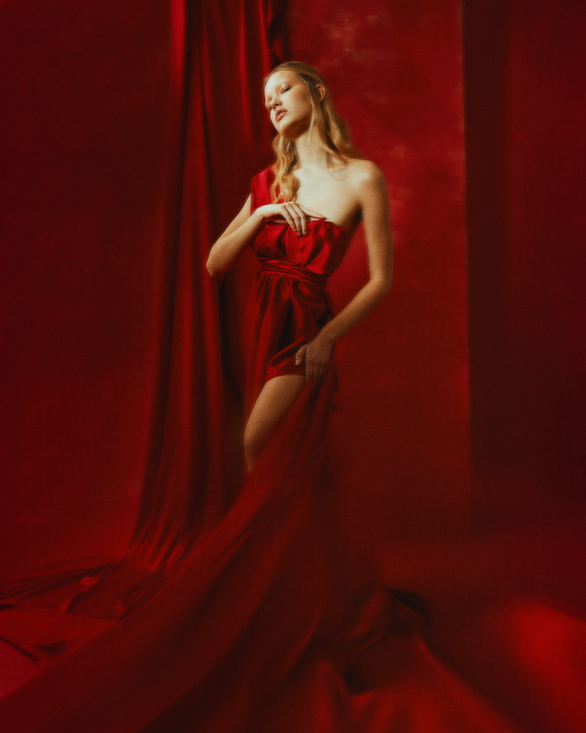 Photography Blond model wearring a Luxury red dress on red background